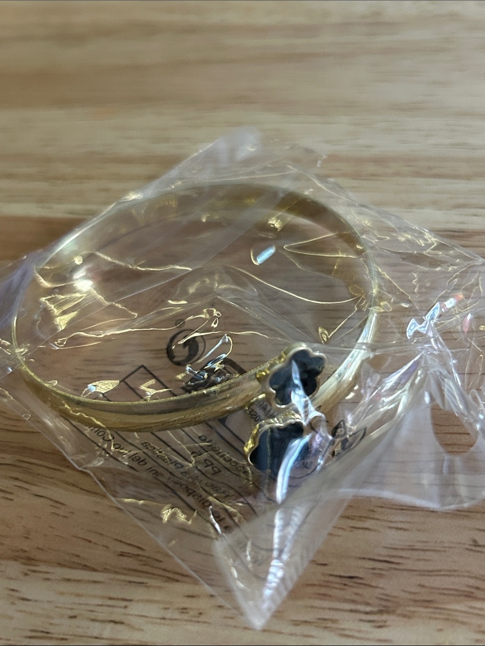 Gold Tone Bangle Bracelet with Black Flower Charms